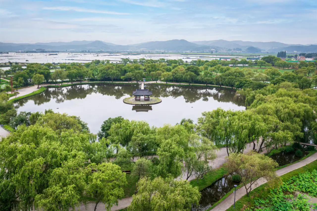 Gungnamji pond with a pavilion on its central island, ringed by willows