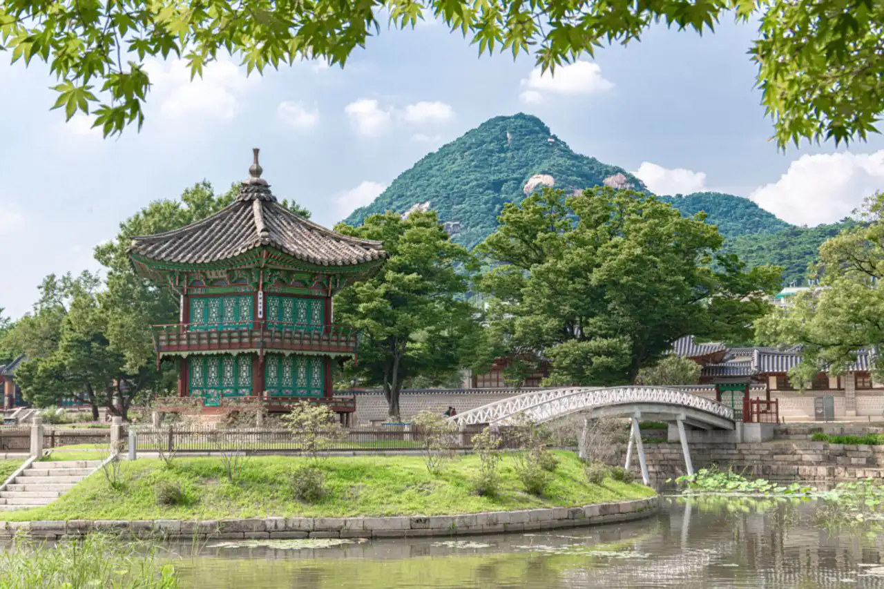 Hyangwonjeong, the hexagonal pavilion on an island in the pond, with its wooden bridge
